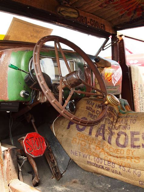 the interior of an old pick up truck with rusted tires and steering ...