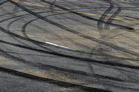 Premium Photo | Tire track mark on asphalt tarmac road race track texture and background ...