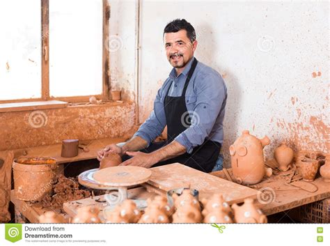 Artisan Man Creating Ceramic Piece on Spinning Pottery Wheel in Stock Photo - Image of cheerful ...