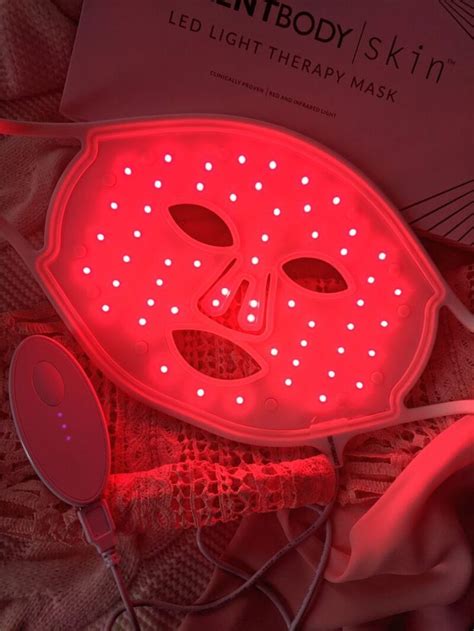 a red light therapy mask on top of a bed