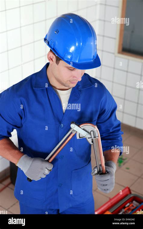 Plumber bending copper pipe hi-res stock photography and images - Alamy