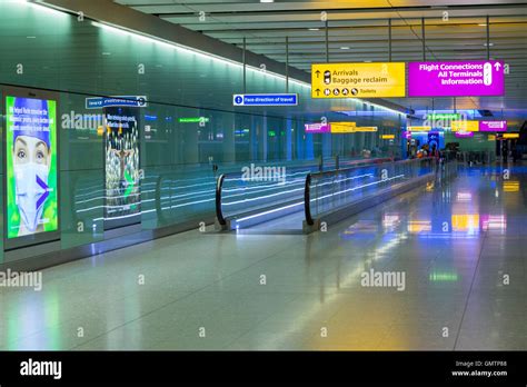 Heathrow Airport corridor / hall leading to arrivals after alighting from airplane & entering ...