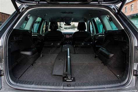 Huge, clean and empty car trunk in interior of a modern compact suv. Rear view of a SUV car with ...