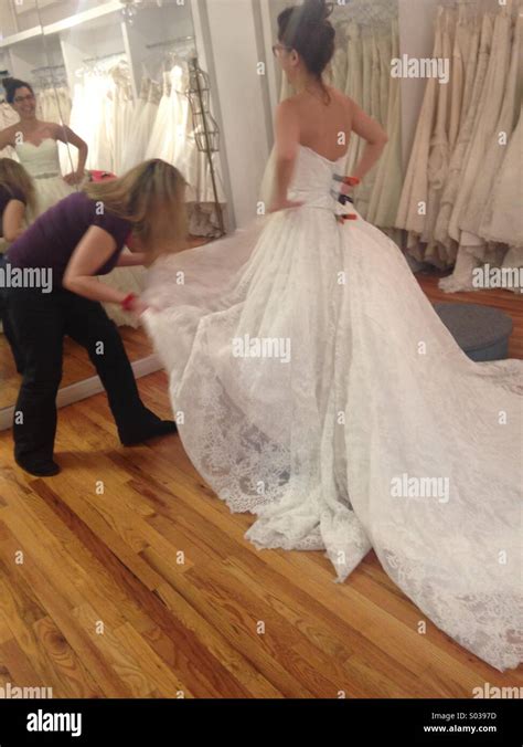 Wedding dress fitting Stock Photo - Alamy