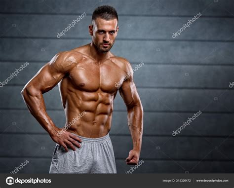 Strong Muscular Men Flexing Muscles Stock Photo by ©mrbigphoto 315326472