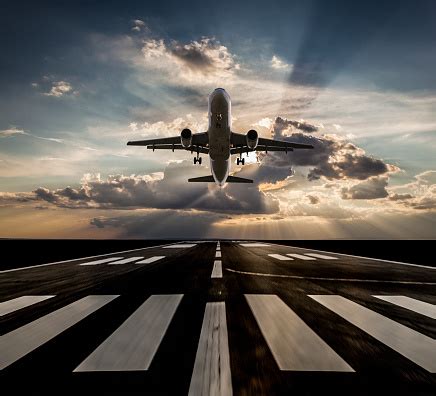 Passenger Airplane Taking Off At Sunset Stock Photo - Download Image ...