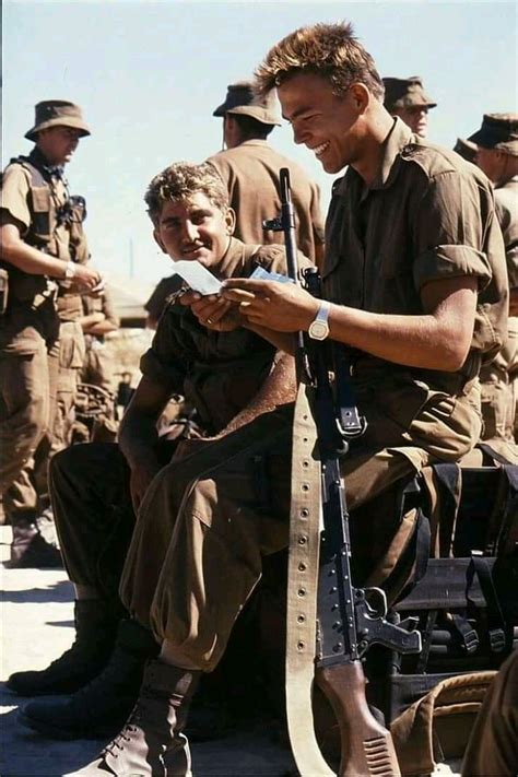 An universal image. A South African soldier reads a letter from a loved one after a tour in the ...