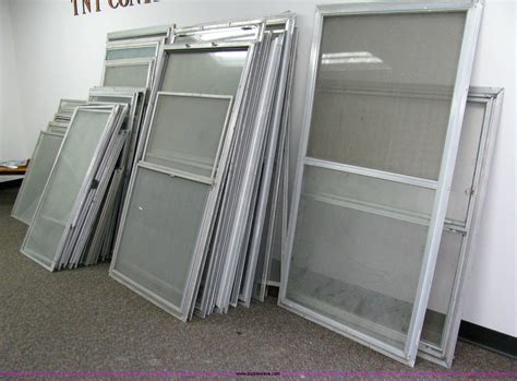 (27) assorted aluminum storm windows with screens in Coffeyville, KS | Item 1001 sold | Purple Wave