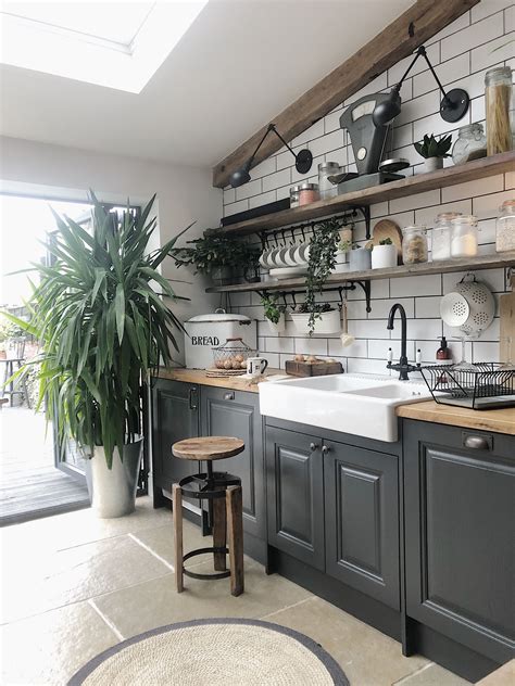 a kitchen filled with lots of pots and pans next to a sink under a window