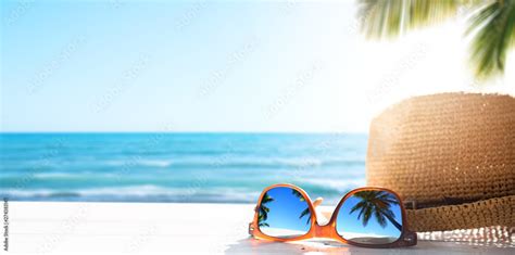 Sunny tropical beach vacation background; glasses and palm tree reflex Stock Photo | Adobe Stock