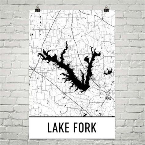 a white brick wall with a black and white poster on it that says lake fork