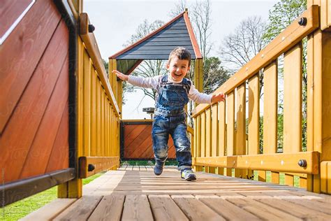 «Preschooler Boy Running At The Playground» del colaborador de Stocksy ...