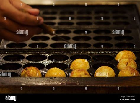 The cooking of Takoyaki. The popular Japanese street food Stock Photo ...