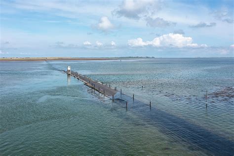 Holy Island Causeway Near High Tide Photograph by Graham Moore | Fine ...