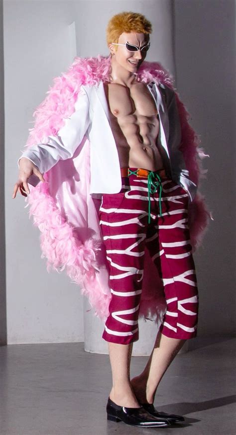 a man in pink and white is posing for the camera