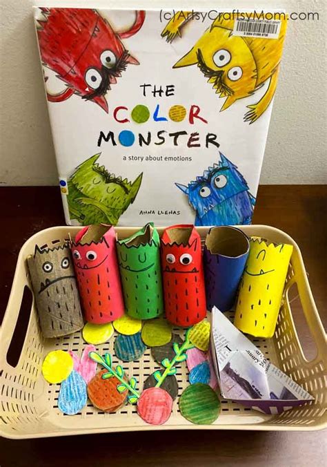 the color monster book is sitting on a tray with paper cups in front of it