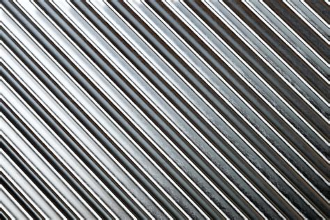 Texture of silver roof metal sheet. Metallic plate texture. Diagonal silver grey stripes ...