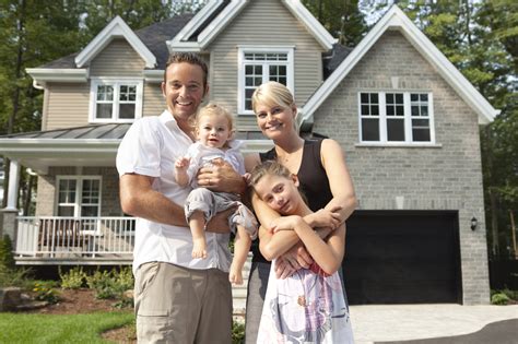 Happy Family In Front Of Their New House | Wesling Electric