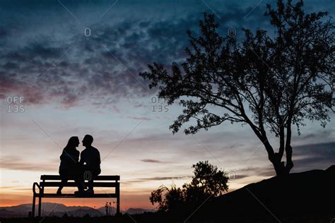 Silhouette Couple Sitting On Bench