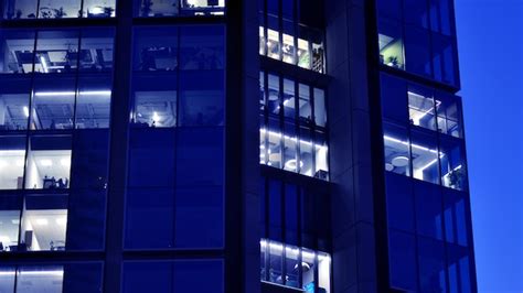 Premium Photo | Fragment of the glass facade of a modern corporate building at night