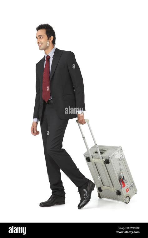 Indian businessman walking with suitcase Stock Photo - Alamy