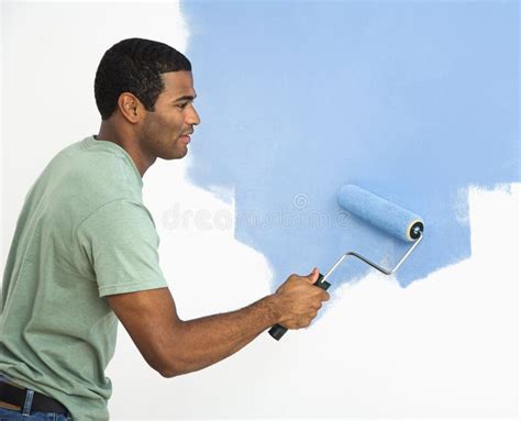 Handsome Man Painting Wall. Stock Image - Image of photograph, blue: 6152567