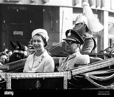 King and Queen of Nepal arrive for State visit . Photo shows: King Mahendra drives with Queen ...