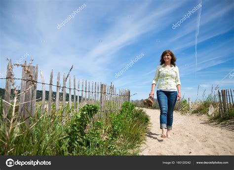 Walking barefoot on the beach Stock Photo by ©asife 160120242