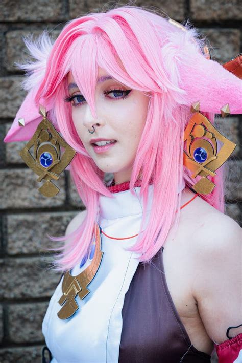 Female Cosplayer in a Pink Anime Costume Wearing Pink Hair Stock Photo - Image of raises ...