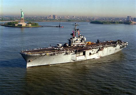 USS Guadalcanal (LPH-7) and her crew salute Lady Liberty at the Port of ...