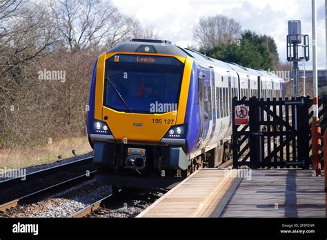 Rail Class 195 train by Northern Rail running through Garforth Station ...