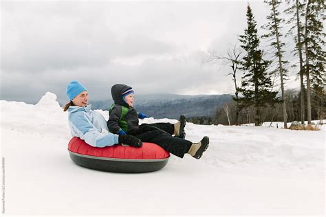 "Family Together Snow Tubing Winter Family Travel Lifestyle" by Stocksy Contributor "Raymond ...