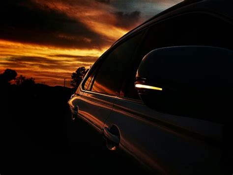 Premium Photo | Cropped car on silhouette landscape at sunset