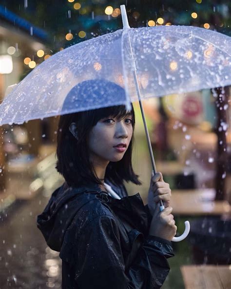 a woman holding an umbrella in the rain