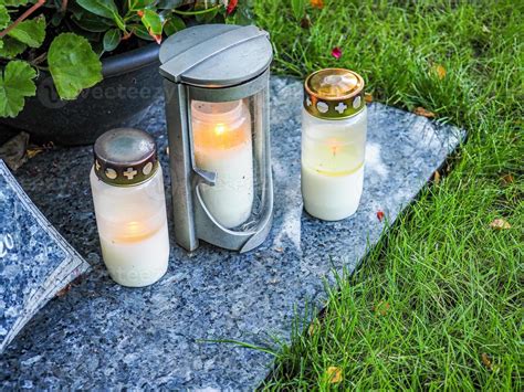 Grave decoration with candle and flowers 7390559 Stock Photo at Vecteezy