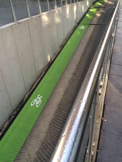 A marked bike lane along a parking garage ramp. : townhall