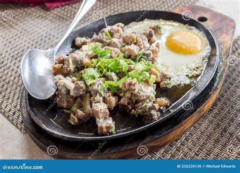 A Serving of Pork Sisig with Egg at an Al Fresco Restaurant. Filipino ...