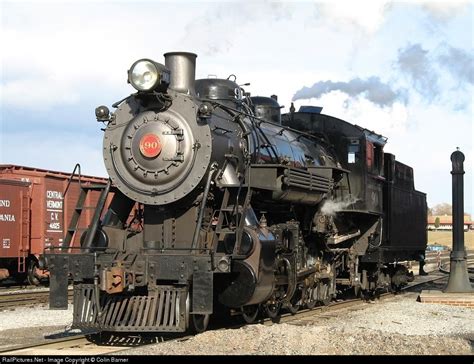 an old fashioned steam engine on the tracks