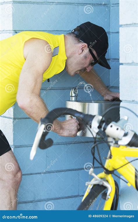 Man at a drinking fountain stock photo. Image of thirst - 48609324