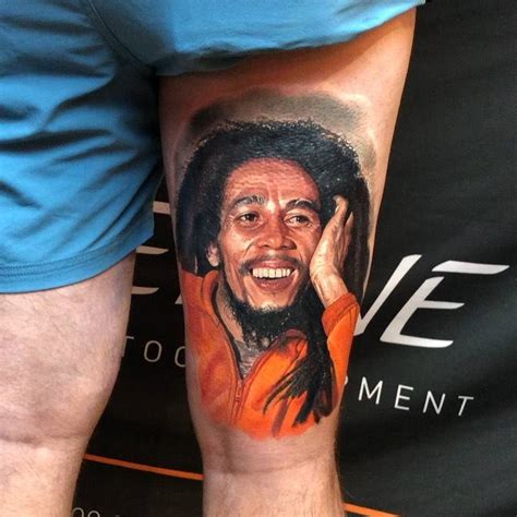 Bob Marley portrait tattoo located on the thigh,