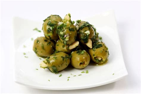 Braised green olives with roasted almonds - Recipes - delicious.com.au