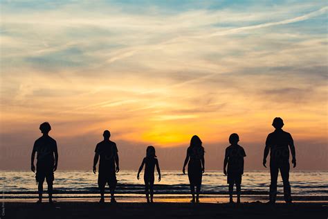 "Silhouettes Of Group Of People On The Beach At Sunset" by Stocksy ...