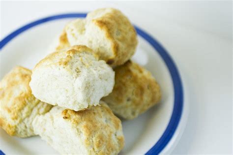 biscuits are stacked on top of each other on a blue and white plate