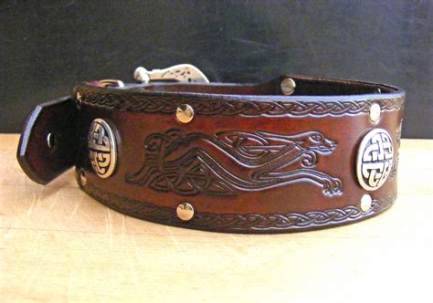 a brown leather belt with celtic designs on it