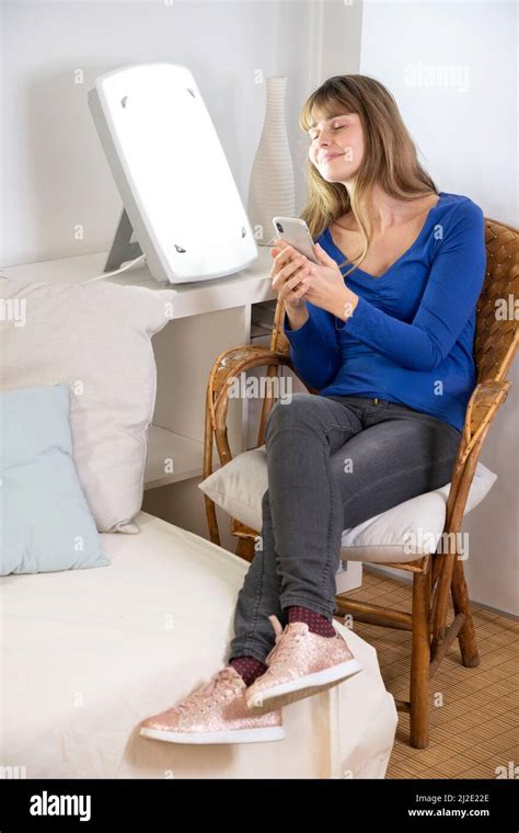 Woman smartphone light therapy Stock Photo - Alamy