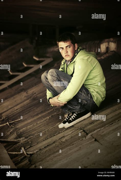 Sad young man in depression outdoor Stock Photo - Alamy