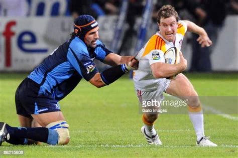 Victor Matfield of Vodacom Bulls tackles Toby Morland of the Chiefs ...