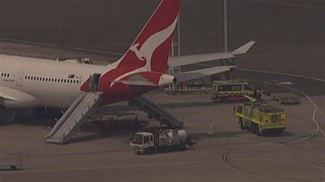 Qantas flight evacuated using slides as cabin starts to fill up with smoke | World News | Sky News