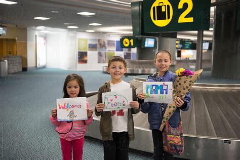 "Kids With Welcome Signs At Airport" by Stocksy Contributor "Ronnie ...