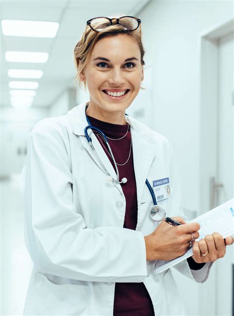 patient-finance-Happy-young-female-doctor-standing-in-hospital corridor ...